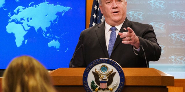 FILE - In this Nov. 10, 2020, file photo, Secretary of State Mike Pompeo gestures toward a reporter while speaking at the State Department in Washington. Pompeo plans to deliver a speech extolling the Trump administration's foreign policy this week in Georgia ahead of key Senate run-off elections that will determine control of the upper chamber of Congress. The accusation of genocide by U.S. Secretary of State Mike Pompeo against China touches on a hot-button human rights issue between China and the West. (AP Photo/Jacquelyn Martin, Pool, File)