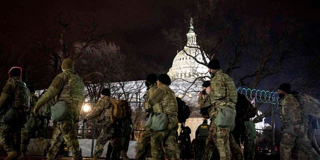 National Guard stand outside the Capitol on Inauguration Day in Washington, D.C. on Wednesday, Jan. 20, 2021. (Erin Schaff/The New York Times via AP, Pool)