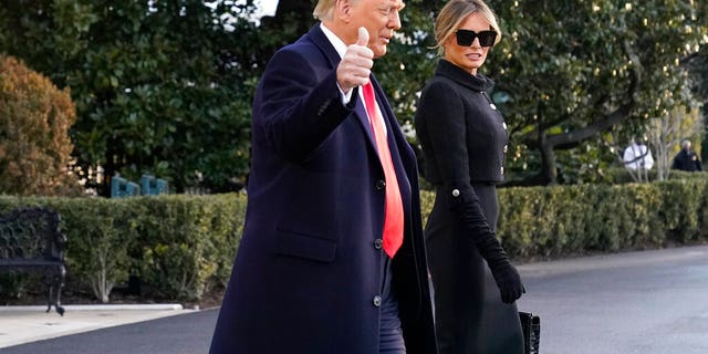 President Donald Trump and first lady Melania Trump walk to board Marine One on the South Lawn of the White House, Wednesday, Jan. 20, 2021, in Washington. Trump is en route to his Mar-a-Lago Florida Resort. (AP Photo/Alex Brandon)