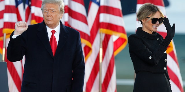 President Donald Trump and first lady Melania Trump wave to supporters after giving a speech at Andrews Air Force Base, Md., Wednesday, Jan. 20, 2021. (AP Photo/Luis M. Alvarez)