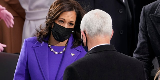 Vice President-elect Kamala Harris talks with Vice President Mike Pence during the 59th Presidential Inauguration at the U.S. Capitol in Washington, Wednesday, Jan. 20, 2021. (AP Photo/Andrew Harnik)