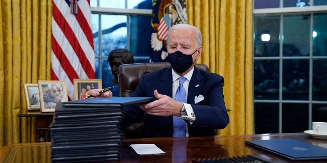 President Joe Biden signs his first executive orders, including one canceling the Keystone XL pipeline's federal permits, in the White House on Jan. 20, 2021.