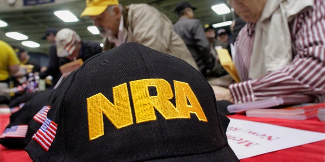 FILE - This photo from Wednesday March 7, 2012, shows Illinois gun owners and supporters file NRA applications during an Illinois Gun Owners Lobby Day convention before marching to the Illinois State in Springfield, Ill. (AP Photo/Seth Perlman, File)