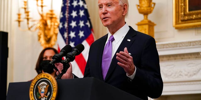 President Joe Biden speaks about the coronavirus, accompanied by Vice President Kamala Harris, in the State Dinning Room of the White House, Thursday, Jan. 21, 2021, in Washington. (AP Photo/Alex Brandon)