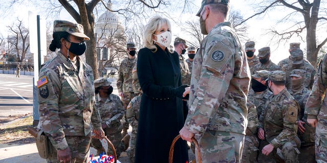 Saying, "The Biden's are a National Guard family," first lady Jill Biden greets members of the National Guard with chocolate chip cookies, Friday, Jan. 22, 2021, at the U.S. Capitol in Washington. (AP Photo/Jacquelyn Martin, Pool)