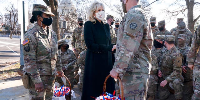 Saying, "The Biden's are a National Guard family," first lady Jill Biden greets members of the National Guard with chocolate chip cookies, Friday, Jan. 22, 2021, at the U.S. Capitol in Washington. (AP Photo/Jacquelyn Martin, Pool)