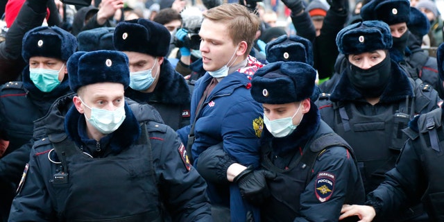 Police detain a man during a protest against the jailing of opposition leader Alexei Navalny in Moscow, Russia, Saturday, Jan. 23, 2021. Russian police are arresting protesters demanding the release of the top Russian opposition leader at demonstrations (AP Photo/Alexander Zemlianichenko)