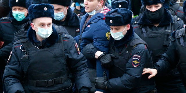 Police detain a man during a protest against the jailing of opposition leader Alexei Navalny in Moscow, Russia, Saturday, Jan. 23, 2021. Russian police are arresting protesters demanding the release of the top Russian opposition leader at demonstrations (AP Photo/Alexander Zemlianichenko)