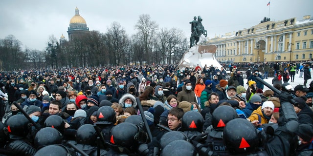 People clash with police during a protest against the jailing of opposition leader Alexei Navalny in St.Petersburg, Russia, Saturday, Jan. 23, 2021. Russian police on Saturday arrested hundreds of protesters who took to the streets in temperatures as low as minus-50 C (minus-58 F) to demand the release of Alexei Navalny, the country's top opposition figure. A Navalny, President Vladimir Putin's most prominent foe, was arrested on Jan. 17 when he returned to Moscow from Germany, where he had spent five months recovering from a severe nerve-agent poisoning that he blames on the Kremlin. (AP Photo/Dmitri Lovetsky)