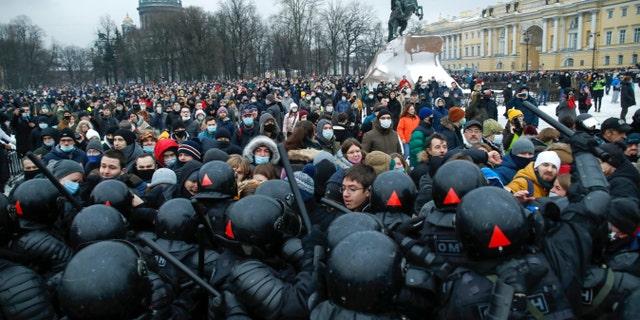 People clash with police during a protest against the jailing of opposition leader Alexei Navalny in St.Petersburg, Russia, Saturday, Jan. 23, 2021. Russian police on Saturday arrested hundreds of protesters who took to the streets in temperatures as low as minus-50 C (minus-58 F) to demand the release of Alexei Navalny, the country's top opposition figure. A Navalny, President Vladimir Putin's most prominent foe, was arrested on Jan. 17 when he returned to Moscow from Germany, where he had spent five months recovering from a severe nerve-agent poisoning that he blames on the Kremlin. (AP Photo/Dmitri Lovetsky)