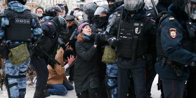 Police detain a man during a protest against the jailing of opposition leader Alexei Navalny in Moscow, Russia, Saturday, Jan. 23, 2021. Russian police on Saturday arrested hundreds of protesters who took to the streets in temperatures as low as minus-50 C (minus-58 F) to demand the release of Alexei Navalny, the country's top opposition figure. A Navalny, President Vladimir Putin's most prominent foe, was arrested on Jan. 17 when he returned to Moscow from Germany, where he had spent five months recovering from a severe nerve-agent poisoning that he blames on the Kremlin. (AP Photo/Alexander Zemlianichenko)