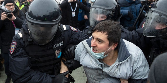 Police officers detain a man during a protest against the jailing of opposition leader Alexei Navalny in Moscow, Russia, Saturday, Jan. 23, 2021. Russian police on Saturday arrested hundreds of protesters who took to the streets in temperatures as low as minus-50 C (minus-58 F) to demand the release of Alexei Navalny, the country's top opposition figure. (AP Photo/Pavel Golovkin)