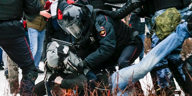 Riot police detain a demonstrator with a bloody face during a protest against the jailing of opposition leader Alexei Navalny in Pushkin square in Moscow, Russia, Saturday, Jan. 23, 2021. (AP Photo/Alexander Zemlianichenko)