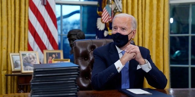 President Joe Biden signs his first executive orders, including one canceling the Keystone XL pipeline's federal permits, in the White House on Jan. 20, 2021.