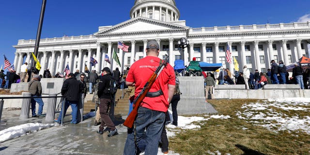FILE: A man carries his weapon during a second amendment gun rally at Utah State Capitol on Feb. 8, 2020, in Salt Lake City.