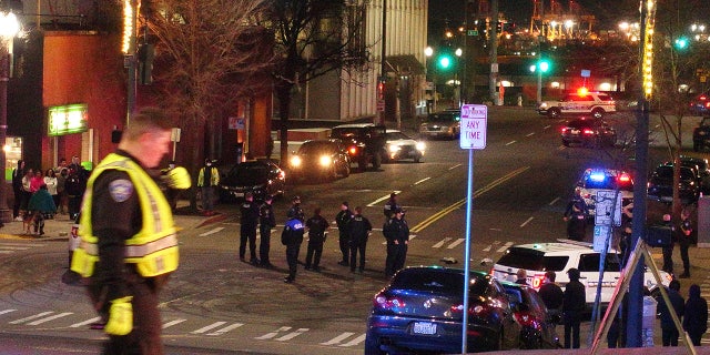 Tacoma police and other law enforcement vehicles are shown near the site of a car crash Saturday, Jan. 23, 2021, in downtown Tacoma, Wash. (Associated Press)