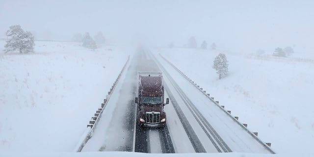 A semi-truck travels on Interstate 40 in Bellemont, Ariz., on Monday.