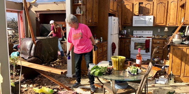 Patti Herring sobs as she sorts through the remains of her home in Fultondale, Alabama on Tuesday, Jan.26, 2021, after being destroyed by a tornado.  (AP Photo / Jay Reeves)