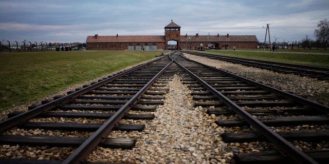 FILE - In this Saturday, Dec. 7, 2019 photo the railway tracks where hundred thousands of people arrived to be directed to the gas chambers inside the former Nazi death camp of Auschwitz Birkenau, or Auschwitz II, are pictured in Oswiecim, Poland. (AP Photo/Markus Schreiber, file)