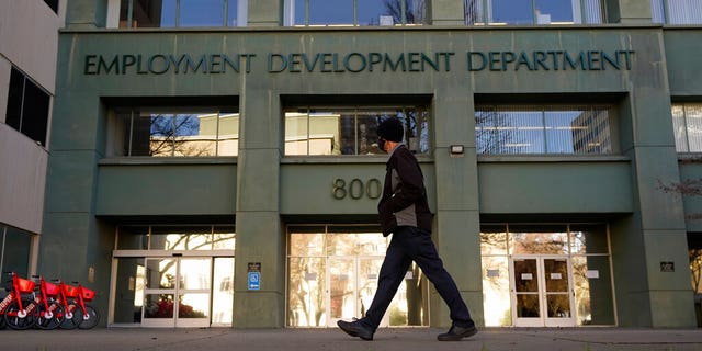 FILE: Person walks past the California Department of Employment Development office in Sacramento, California. 