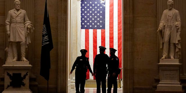 Capitol Police officers talk in the Capitol Rotunda on Capitol Hill in Washington, Monday evening, Jan. 25, 2021.
