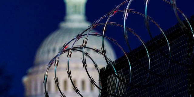 In this Jan. 19, 2021 photo, riot fencing and razor wire reinforce the security zone on Capitol Hill in Washington. 