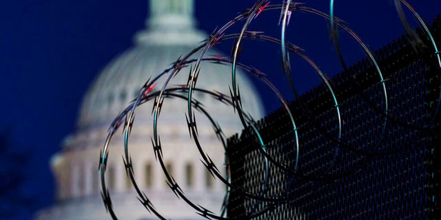 In this Jan. 19, 2021 photo, riot fencing and razor wire reinforce the security zone on Capitol Hill in Washington.