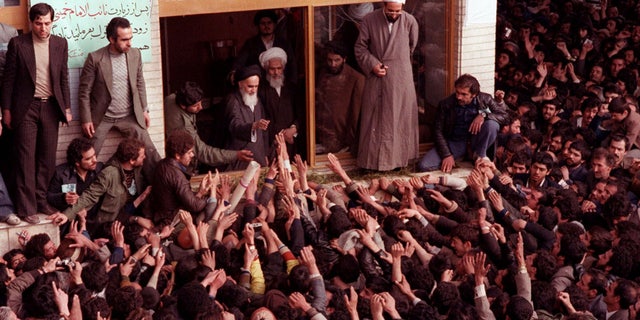 Ayatollah Ruhollah Khomeini is greeted by supporters after arriving at the airport in Tehran Iran, on Feb. 1, 1979. (AP Photo)