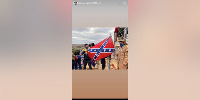 Bryan Betancur, left, posing with Confederate flag on Jan. 6 at the Capitol riot.