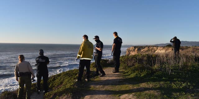 Authorities look into the Pacific Ocean during a search for a California boy, 2, who was pulled under about 100 offshore.