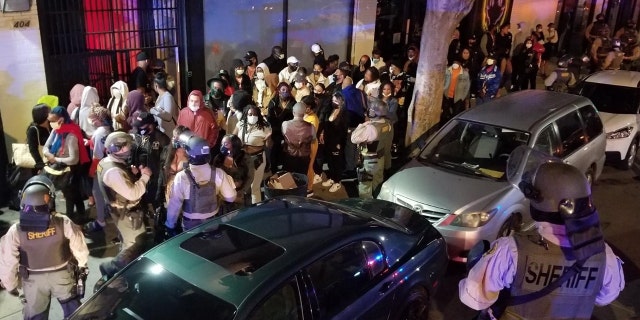 Photos of the arrests posted by the sheriff’s department show some partygoers wearing face masks, and others without them.