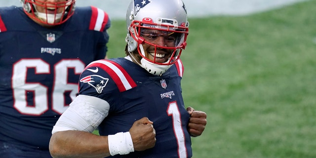 New England Patriots quarterback Cam Newton, right, celebrates his touchdown catch of a pass thrown by wide receiver Jakobi Meyers as offensive lineman James Ferentz (66) joins him during the second half of an NFL football game against the New York Jets, Sunday, Jan. 3, 2021, in Foxborough, Mass. (AP Photo/Elise Amendola)