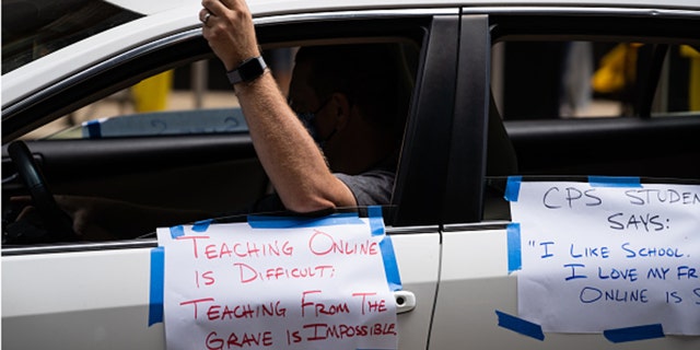 Members and supporters of the Chicago Teachers Union join a caravan of cars in front of Chicago Public School Headquarters as a Chicago Board of Education meeting takes place in Chicago on July 22, 2020 (Photo by Max Herman / NurPhoto via Getty Images)