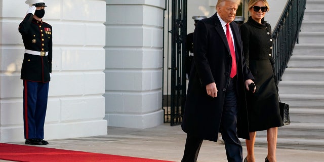 President Donald Trump and first lady Melania Trump walk to board Marine One on the South Lawn of the White House, Wednesday, Jan. 20, 2021, in Washington. Trump is en route to his Mar-a-Lago Florida Resort. (AP Photo/Alex Brandon)