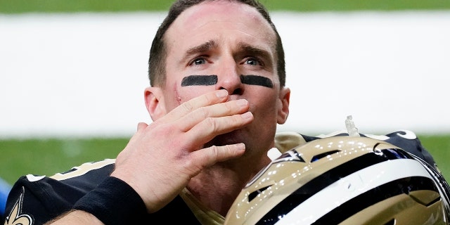 Saints quarterback Drew Brees waves to his family and fans after a playoff game against the Tampa Bay Buccaneers, Jan. 17, 2021, in New Orleans.