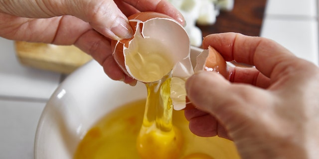 Three eggs are shown cracked into a bowl. The recipe described here from Casey Corn calls for three egg yolks. 