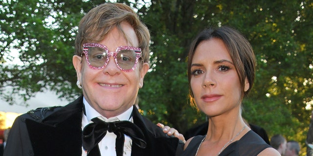 Victoria Beckham (right) said watching Elton John (left) perform 'Tiny Dancer' helped her realize she wanted to quit the music industry.  (Photo by David M. Benett / Dave Benett / Getty Images for BVLGARI and EJAF)