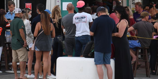People pack Fort Lauderdale bars Sunday, when the state of Florida reported another 10,603 COVID-19 cases, the eighth consecutive day with an average of 11,000-plus new cases per day.