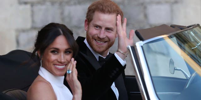 Meghan Markle and Prince Harry wave outside Windsor Castle on May 19, 2018 in Windsor, England.  (Getty Images)