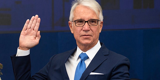 Los Angeles County District Attorney George Gascon is sworn in as his wife Fabiola Kramsky holds a copy of the Constitution during a mostly-virtual ceremony in downtown Los Angeles on Dec. 7, 2020. Gascon, who co-authored a 2014 ballot measure to reduce some nonviolent felonies to misdemeanors, has promised more reforms to keep low-level offenders, drug users and those who are mentally ill out of jail and has said he won't seek the death penalty. (Bryan Chan/County of Los Angeles via AP)