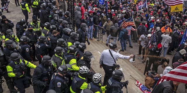 Pepper spray is used against demonstrators as they breach the U.S. Capitol building grounds in Washington, D.C., on Wednesday, Jan. 6, 2021. The U.S. Capitol was placed under lockdown and Vice President Mike Pence left the floor of Congress as hundreds of protesters swarmed past barricades surrounding the building where lawmakers were debating Joe Biden's victory in the Electoral College. (Victor J. Blue/Bloomberg via Getty Images)