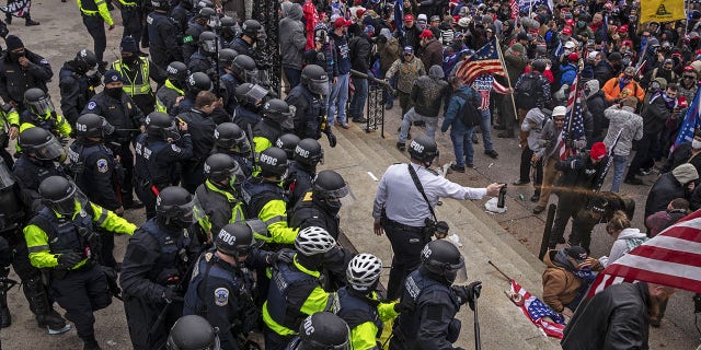 Pepper spray is used against demonstrators as they breach the U.S. Capitol building grounds in Washington, D.C., on Wednesday, Jan. 6, 2021. The U.S. Capitol was placed under lockdown and Vice President Mike Pence left the floor of Congress as hundreds of protesters swarmed past barricades surrounding the building where lawmakers were debating Joe Biden's victory in the Electoral College. (Victor J. Blue/Bloomberg via Getty Images)