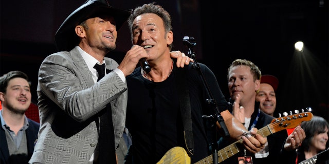 Bruce Springsteen (right) explained how country crooner Tim McGraw (left) cheered him up after losing 'Album of the Year.'