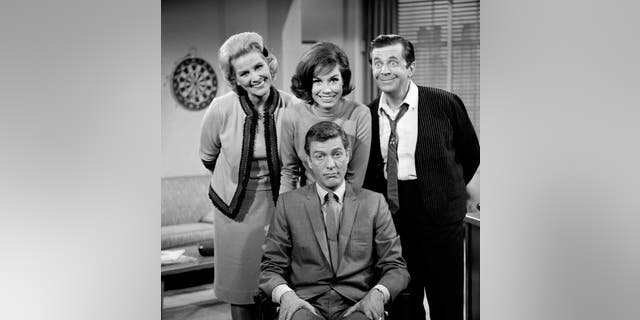 'The Dick Van Dyke Show' cast: <br> Standing, left to right: Rose Marie, Mary Tyler Moore, Morey Amsterdam; (seated) Dick Van Dyke. Image dated 1961.