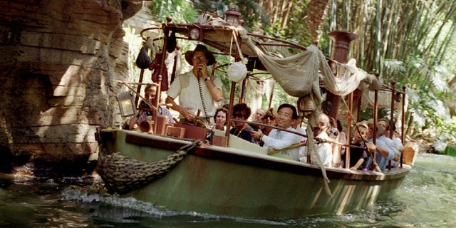 A photo of a group of tourists on the Jungle Cruise at Disneyland.