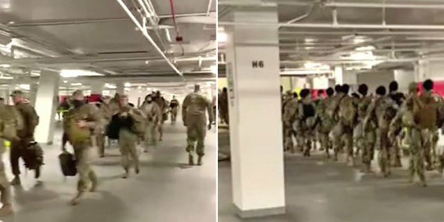 National Guard Troops leave a parking garage amid controversy over the fact that soldiers were ordered to rest there during their 12-hour shifts.