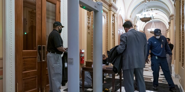 Metal detectors for lawmakers are installed in the corridor around the House of Representatives chamber after a mob loyal to President Donald Trump stormed the Capitol last week, in Washington, Tuesday, Jan. 12, 2021.