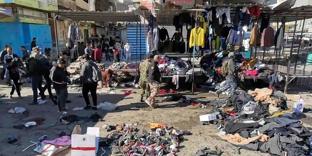 <br>
People and security forces gather at the site of a deadly bomb attack in a market selling used clothes, in Baghdad, Iraq, Jan. 21, 2021. (Associated Press)