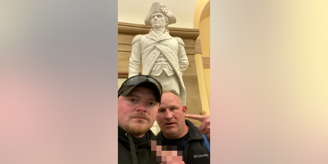 Police officers Jacob Fracker and Thomas Robertson took a selfie inside the U.S. Capitol during an insurrection.