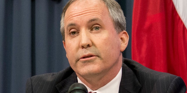 Texas Gov. Greg Abbott, l, and Attorney General Ken Paxton hold a press conference to address a Texas federal court's decision on the immigration lawsuit filed by 26 states challenging President Obama. Paxton was indicted Monday on three counts of securities fraud unrelated to his official duties. (Photo by Robert Daemmrich Photography Inc/Corbis via Getty Images)